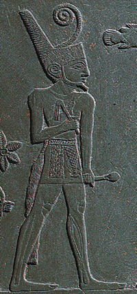Narmer, wearing the Red Crown, inspects the slain corpses of his enemies on the front of his Palette.